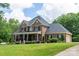 Beautiful brick home with attached garage, lush lawn, and covered front porch at 106 Hannaford Pl # 15, Gastonia, NC 28052