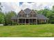Charming two-story brick home featuring a covered porch and well-manicured lawn at 106 Hannaford Pl # 15, Gastonia, NC 28052