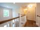 Upstairs hallway with hardwood floors and white banister at 106 Hannaford Pl # 15, Gastonia, NC 28052