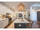 Modern kitchen with white cabinets, a large island, and stylish pendant lighting at 106 Hannaford Pl # 15, Gastonia, NC 28052