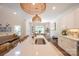 Open-concept kitchen boasts large center island with seating, modern pendant lighting, and stainless sink at 106 Hannaford Pl # 15, Gastonia, NC 28052