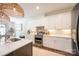 Gourmet kitchen features stainless steel appliances, white cabinetry and stone backsplash at 106 Hannaford Pl # 15, Gastonia, NC 28052