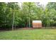 Outdoor storage shed located in fenced backyard with mature trees at 106 Hannaford Pl # 15, Gastonia, NC 28052