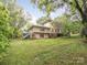 Secluded backyard featuring a lush lawn, mature trees and a quaint deck, creating a serene outdoor space at 1120 N College St, Mount Pleasant, NC 28124