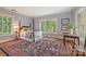 Bedroom featuring a patterned rug, a four-poster bed, and natural light at 1120 N College St, Mount Pleasant, NC 28124