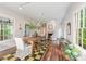 Bright dining room with hardwood floors, a large wooden table, and lots of natural light at 1120 N College St, Mount Pleasant, NC 28124