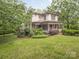 Charming two-story home with inviting front porch, surrounded by lush greenery at 1120 N College St, Mount Pleasant, NC 28124