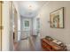 Hallway with wooden floors, white walls, and a chest with books on top at 1120 N College St, Mount Pleasant, NC 28124