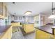 Traditional kitchen featuring yellow cabinetry, a large island with dark countertops, and tile flooring at 1120 N College St, Mount Pleasant, NC 28124