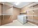 Well-organized laundry room with shelving, washer and dryer, and ample storage space at 1120 N College St, Mount Pleasant, NC 28124