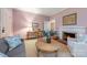 Inviting living room with pink walls, fireplace, natural light, and stylish furnishings at 1120 N College St, Mount Pleasant, NC 28124