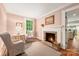Charming room with a fireplace, hardwood floors, and a cozy seating area; perfect for relaxation at 1120 N College St, Mount Pleasant, NC 28124
