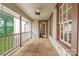 Charming porch with wooden flooring, white railings, and a ceiling fan for comfortable outdoor relaxation at 1120 N College St, Mount Pleasant, NC 28124