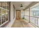 Inviting front porch with wood floors, white railings, and windows overlooking the front yard at 1120 N College St, Mount Pleasant, NC 28124