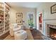 Cozy sitting room with a fireplace, built-in bookshelves, and a window offering a view of the outdoors at 1120 N College St, Mount Pleasant, NC 28124