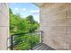 Outdoor balcony with steel railing offers a view of lush greenery and the surrounding neighborhood at 1162 E 36Th St, Charlotte, NC 28205