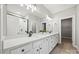 Modern bathroom with double sinks, white cabinets, and a glass-enclosed shower at 1162 E 36Th St, Charlotte, NC 28205