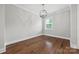 Light-filled bedroom boasts hardwood floors, modern globe lighting, and a bright window at 1162 E 36Th St, Charlotte, NC 28205