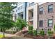 Modern townhome with brick and stone facade, red door, and landscaped front yard at 1162 E 36Th St, Charlotte, NC 28205