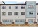 Exterior view of townhome garages with light blue doors and individual unit numbers at 1162 E 36Th St, Charlotte, NC 28205