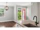 Bright kitchen featuring a red door leading to the outside and contemporary globe lighting fixture at 1162 E 36Th St, Charlotte, NC 28205