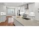 Bright kitchen featuring white cabinets, stainless steel appliances, and an island with seating at 1162 E 36Th St, Charlotte, NC 28205