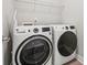 Laundry room with modern washer and dryer, and wire shelving for storage at 1162 E 36Th St, Charlotte, NC 28205