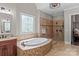 Large bathroom features a soaking tub and tiled shower at 129 Alder Springs Ln, Mooresville, NC 28117