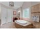 Bright bathroom featuring a soaking tub, tiled walls, decorative window and bronze-toned fixtures at 129 Alder Springs Ln, Mooresville, NC 28117