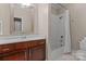 Neutral bathroom features a shower-tub combination and a wood vanity with a mirror at 129 Alder Springs Ln, Mooresville, NC 28117