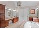 Spacious bathroom with and wood vanities with marble countertops and a soaking tub at 129 Alder Springs Ln, Mooresville, NC 28117