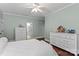 Bright bedroom features hardwood floors, two dressers and a ceiling fan at 129 Alder Springs Ln, Mooresville, NC 28117