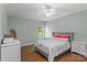 Well-lit bedroom features two dressers, hardwood floors, and a comfy bed at 129 Alder Springs Ln, Mooresville, NC 28117