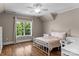 Cozy bedroom features hardwood floors, a queen bed and large window with outdoor views at 129 Alder Springs Ln, Mooresville, NC 28117