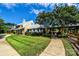 Exterior view of community clubhouse with covered walkway and nicely manicured lawn at 129 Alder Springs Ln, Mooresville, NC 28117