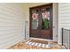 Welcoming double front doors adorned with wreaths, complemented by a 'Welcome' sign and stone porch at 129 Alder Springs Ln, Mooresville, NC 28117