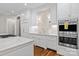 Elegant kitchen with custom white cabinetry, stainless steel appliances, and marble counters at 129 Alder Springs Ln, Mooresville, NC 28117