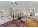 Open-concept living area with view to kitchen, hardwood floors, and comfortable seating at 129 Alder Springs Ln, Mooresville, NC 28117