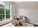 Bright home office has a light colored rug and large window with backyard views at 129 Alder Springs Ln, Mooresville, NC 28117