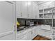 Butler's pantry featuring black granite countertops, white cabinetry, and stainless steel sink at 129 Alder Springs Ln, Mooresville, NC 28117