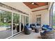 Outdoor porch features outdoor seating and large sliding glass doors to the home's interior at 129 Alder Springs Ln, Mooresville, NC 28117