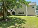 Backyard view featuring a lush lawn and the rear of the home at 13913 Pinyon Pine Ln, Charlotte, NC 28215