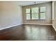 This light-filled bedroom features vinyl floors and ample windows at 13913 Pinyon Pine Ln, Charlotte, NC 28215