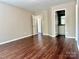 Bedroom with neutral walls and wood floors, bathroom is visible through doorway at 13913 Pinyon Pine Ln, Charlotte, NC 28215