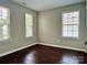 Bedroom with three windows and wood floors at 13913 Pinyon Pine Ln, Charlotte, NC 28215
