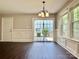 Dining room featuring sliding glass doors to patio, chandelier, and wainscoting at 13913 Pinyon Pine Ln, Charlotte, NC 28215