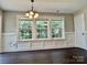 Bright dining room with elegant chandelier, large windows, and classic wainscoting at 13913 Pinyon Pine Ln, Charlotte, NC 28215