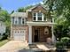 Charming two-story home featuring a brick facade and stone accents, complemented by lush landscaping at 13913 Pinyon Pine Ln, Charlotte, NC 28215