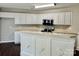 Clean kitchen with white cabinetry, stainless steel appliances, and a convenient island with sink at 13913 Pinyon Pine Ln, Charlotte, NC 28215