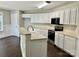 Well-lit kitchen with white cabinets, stainless steel appliances, and a functional center island at 13913 Pinyon Pine Ln, Charlotte, NC 28215